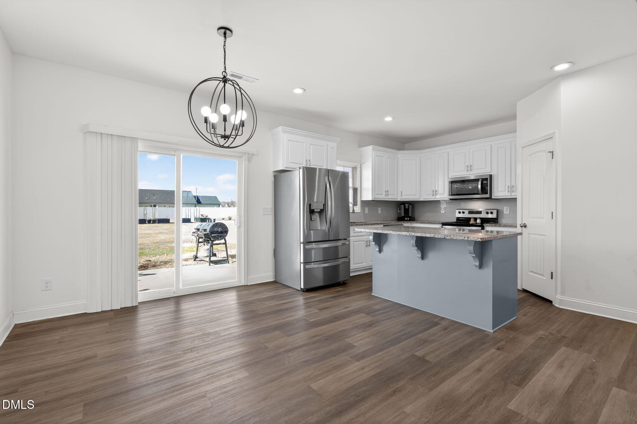 9084 Byron Court Bailey, NC 27807 - Photo 13 of 40 a kitchen with stainless steel appliances granite countertop a wooden floors a stove a microwave and a refrigerator