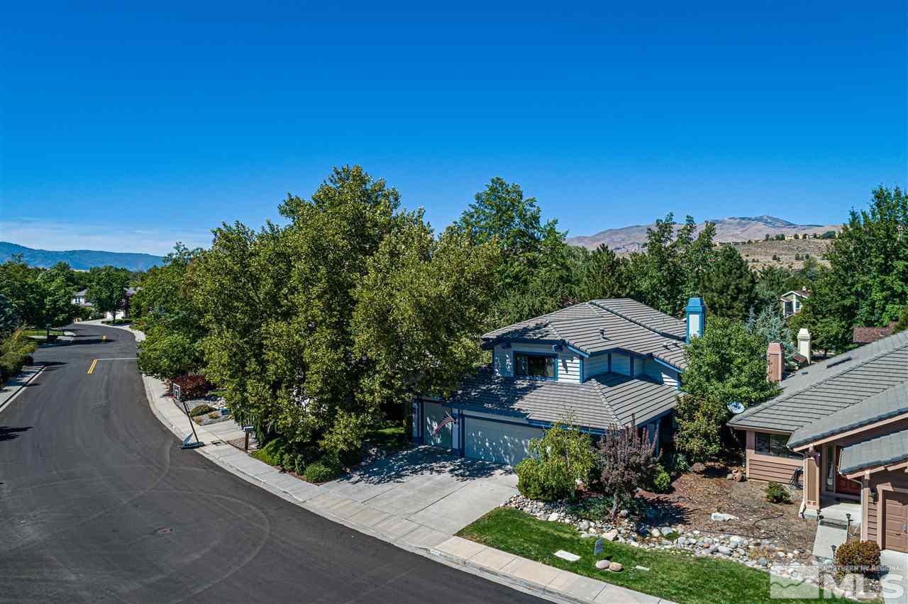 3985 Falling Water Drive Reno, NV 89519 - Photo 3 of 40 a view of a backyard with table and chairs under an umbrella