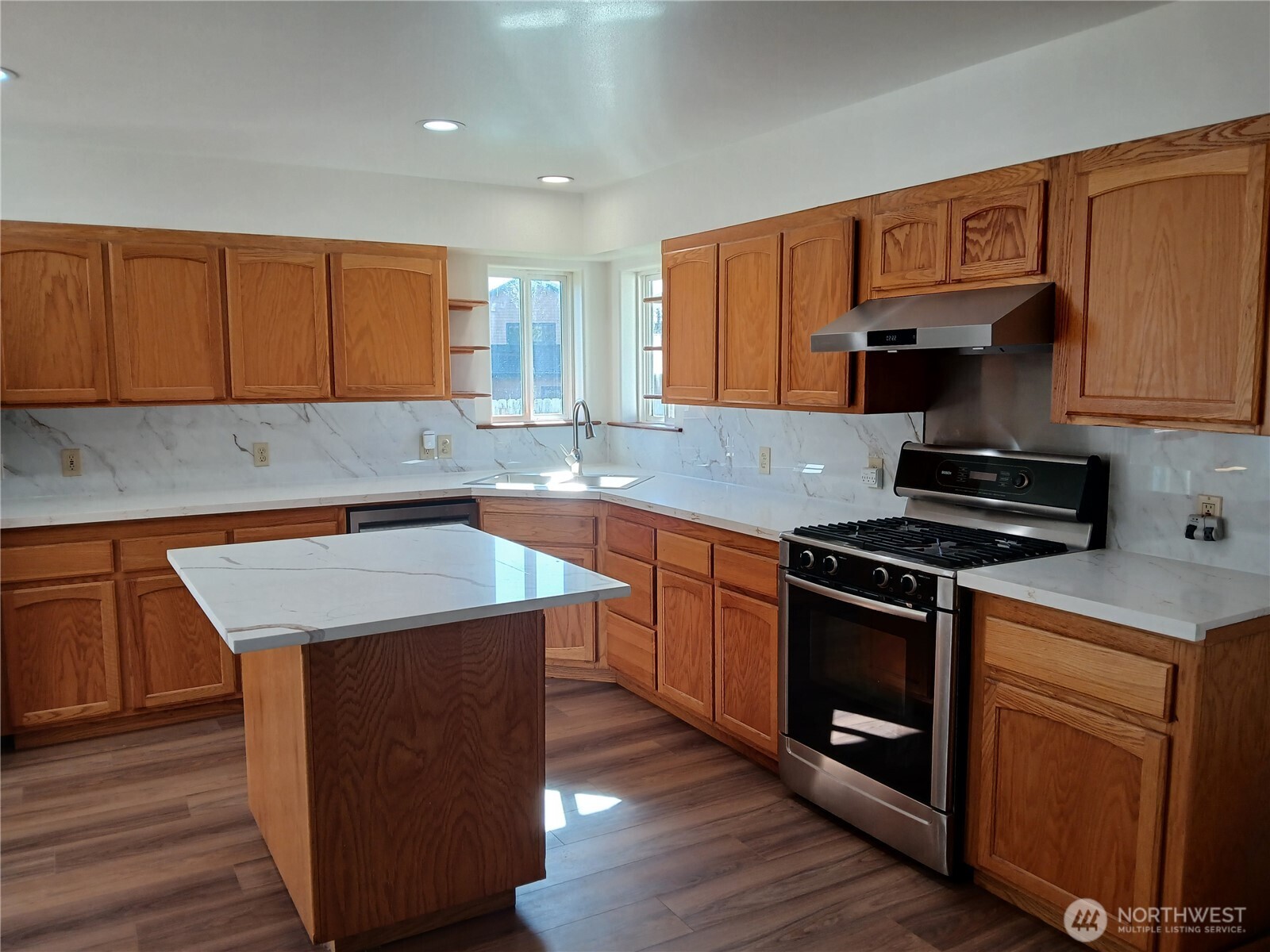 10 Spruce South Bend, WA 98586 - Photo 14 of 29 a kitchen with stainless steel appliances granite countertop a stove a sink dishwasher and a microwave oven with wooden cabinets