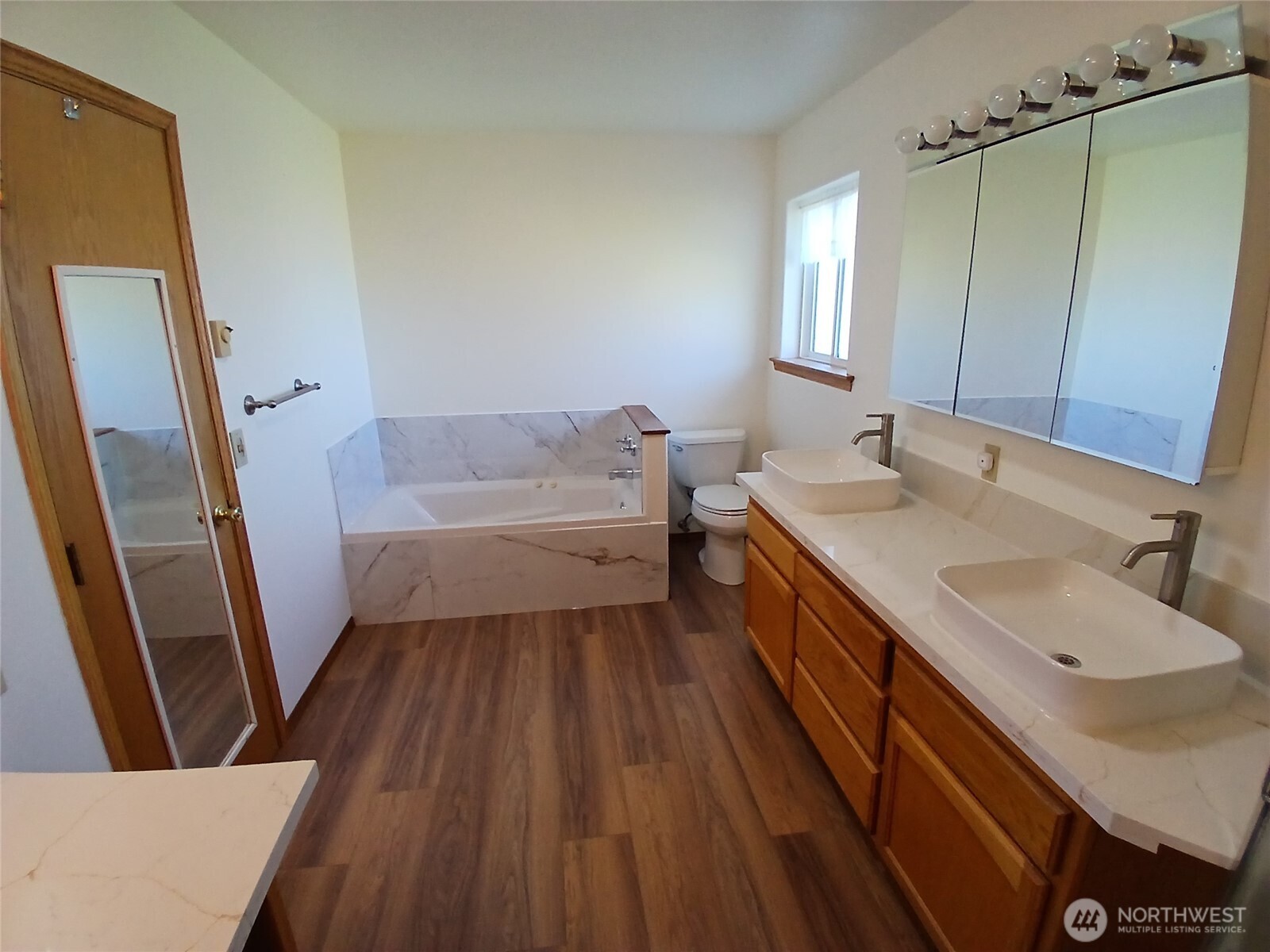 10 Spruce South Bend, WA 98586 - Photo 22 of 29 a bathroom with a sink a mirror and a toilet