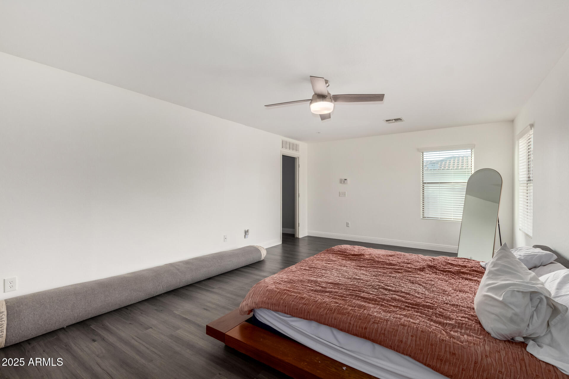 9415 West Eaton Road Phoenix, AZ 85037 - Photo 23 of 36 a bedroom with a bed and a chandelier