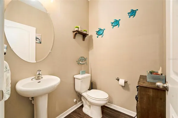 a bathroom with a sink toilet and mirror