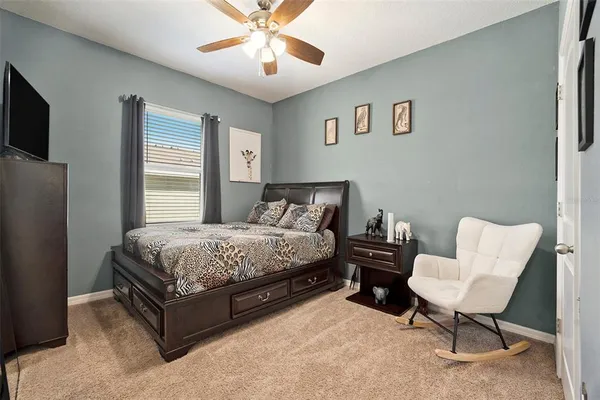 a bedroom with a bed and a chandelier