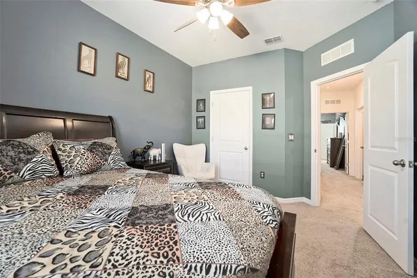 a bedroom with a large bed and a chandelier
