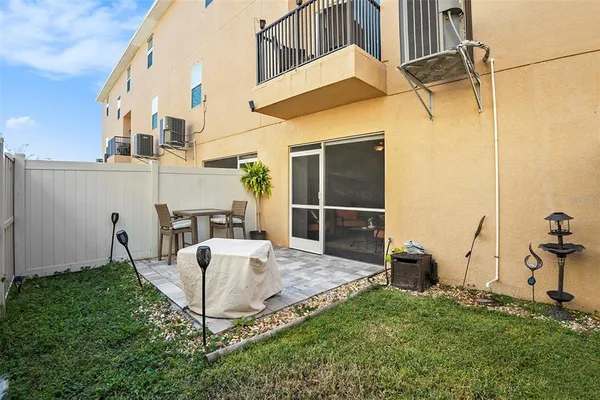 a view of a patio with table and chairs a barbeque