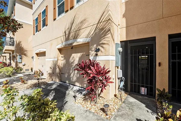 a view of a street with potted plants