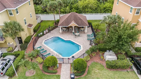 an aerial view of house with yard and swimming pool