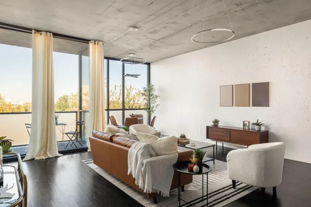 a living room with furniture and a floor to ceiling window