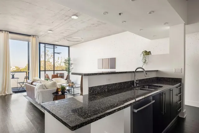 a kitchen with granite countertop a sink and a counter top space