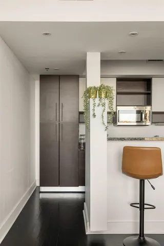 a kitchen with stainless steel appliances a refrigerator and a wooden cabinets