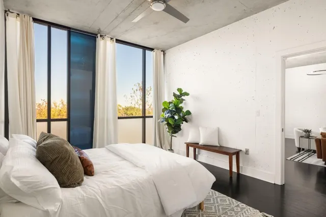 a bedroom with a bed table and chair