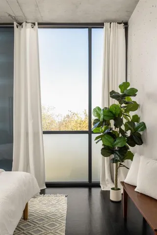 a bedroom with a bed and a window