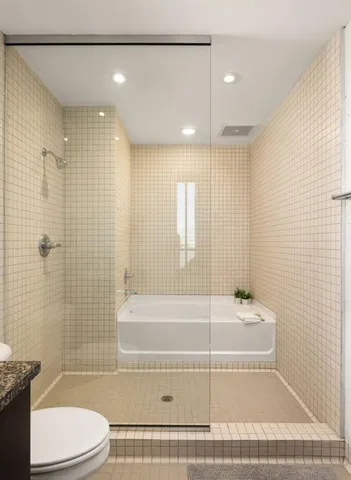 a bedroom with a bed and a lamp