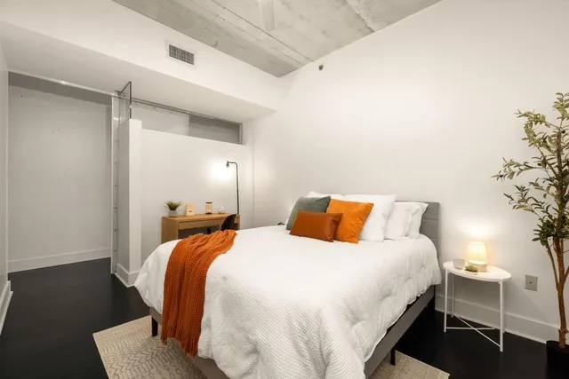 a bathroom with a granite countertop sink a toilet a mirror a shower and a bathtub