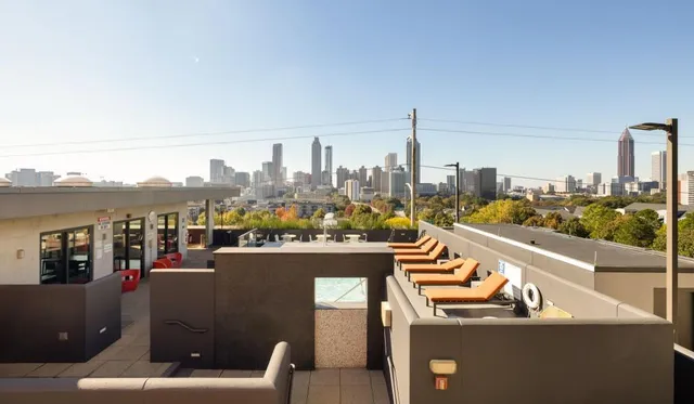 a view of a house with swimming pool and sitting area