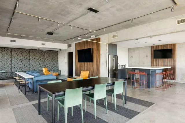 a living room with furniture a rug and a floor to ceiling window