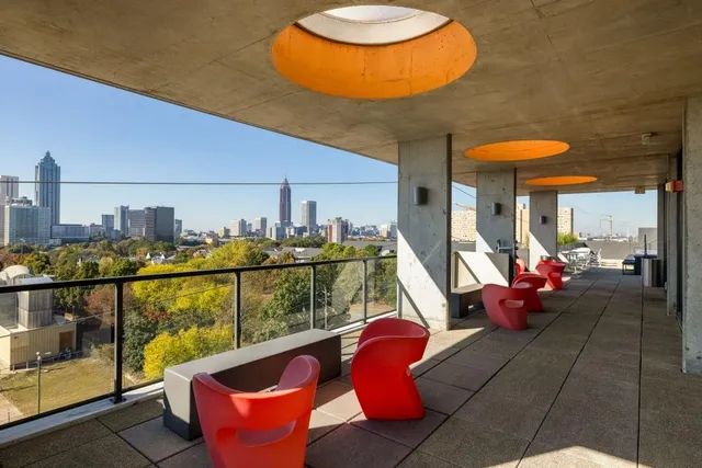 a view of a chair and tables in the balcony