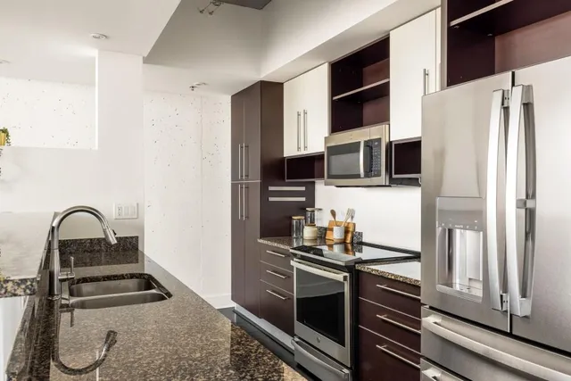 a kitchen with a refrigerator and a stove