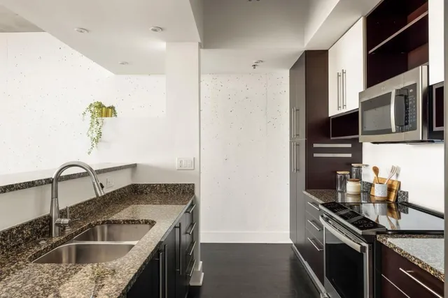 a kitchen that has a sink and a stove