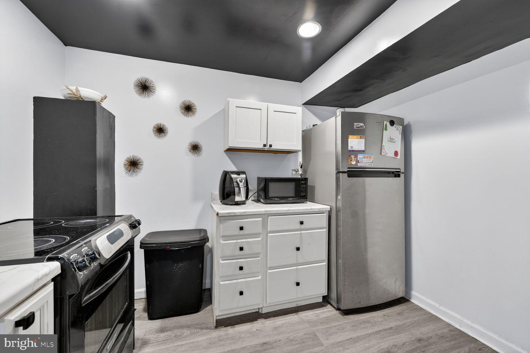 1104 Caddington Avenue Silver Spring, MD 20901 - Photo 26 of 35 a kitchen with cabinets appliances and wooden floor