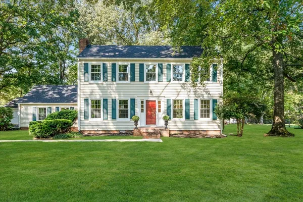 a front view of house with yard and green space
