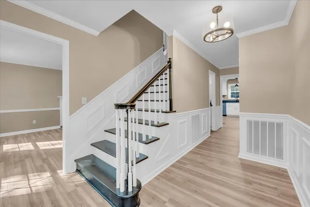 a view of entryway and hall with wooden floor