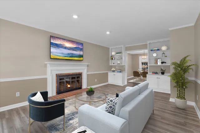 a living room with furniture a fireplace and a potted plant