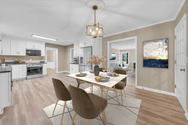 a view of a dining room with furniture wooden floor and chandelier