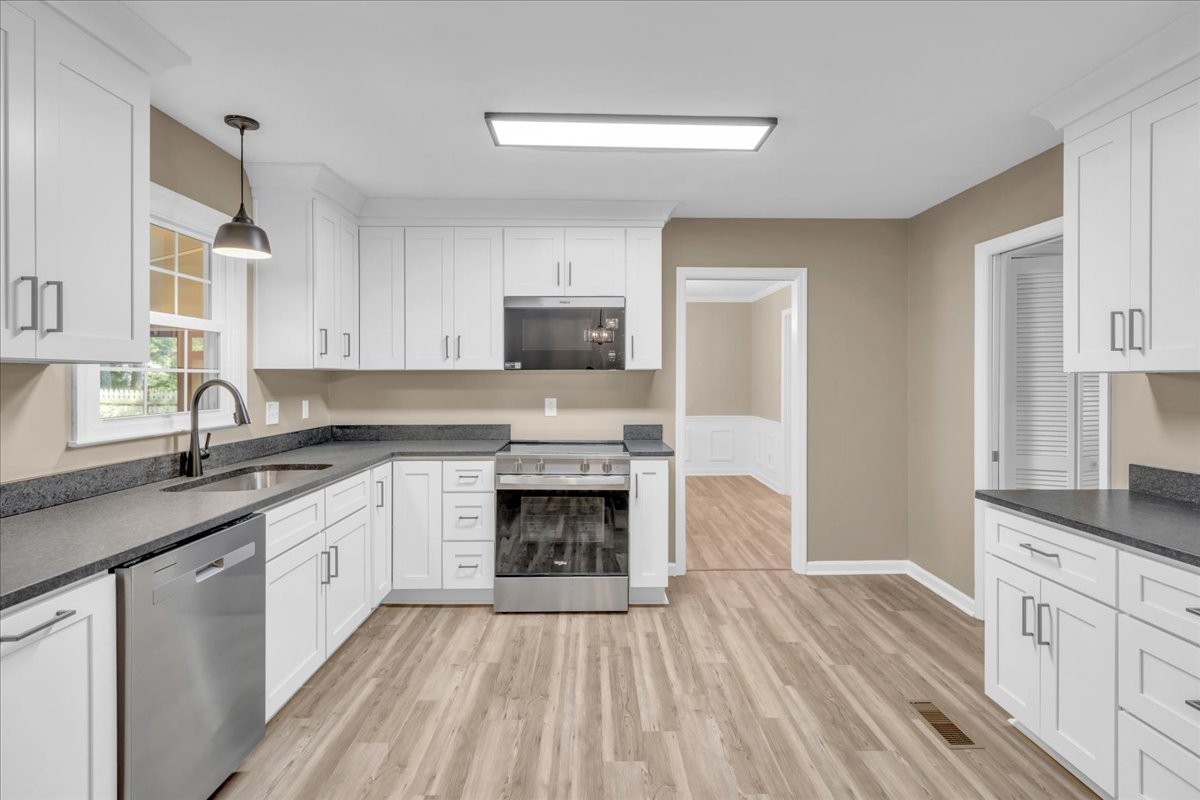302 Marbeth Lane Tullahoma, TN 37388 - Photo 26 of 50 a kitchen with granite countertop a sink stove and cabinets