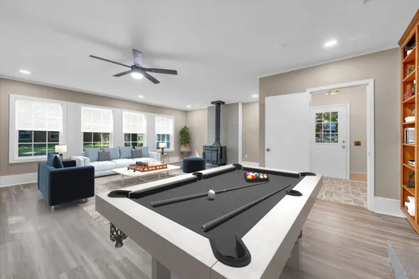 a living room with furniture flat screen tv and large window