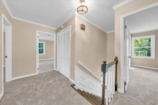 a view of a hallway view with staircase