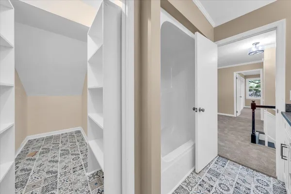 a view of a hallway with windows and closet