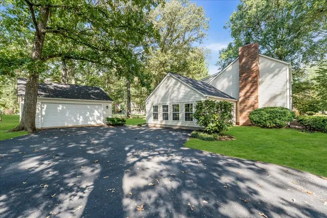 a view of house with outdoor space and garden