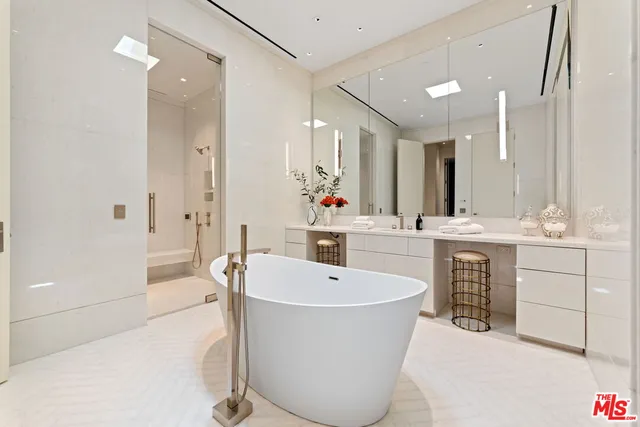 a spacious bathroom with a tub and a mirror