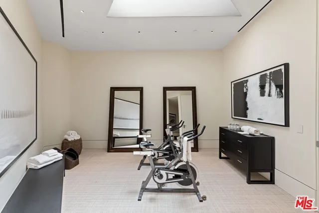 a room with gym equipment and a large window