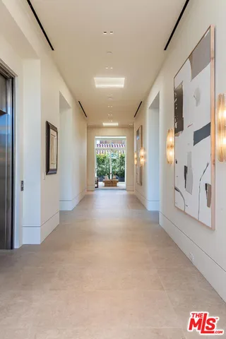 a large white kitchen with a large window