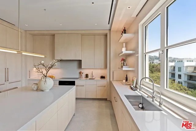 a kitchen with a sink a stove and chairs