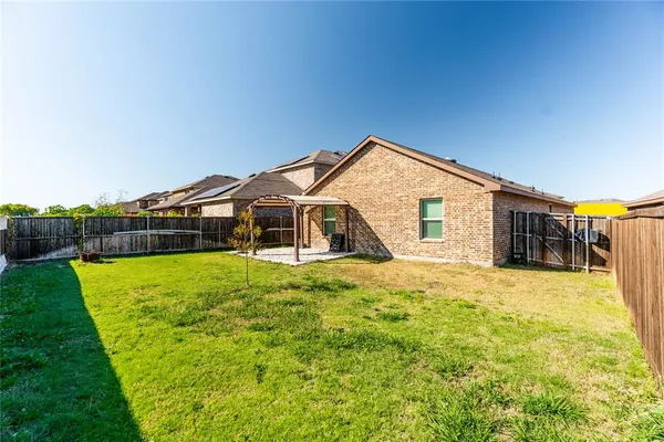 a front view of house with a garden