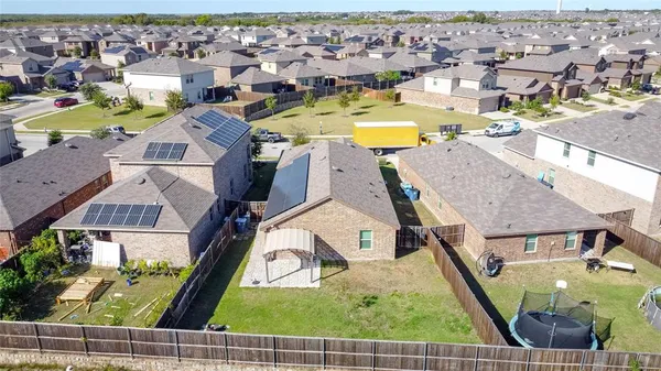 an aerial view of residential houses with outdoor space and swimming pool