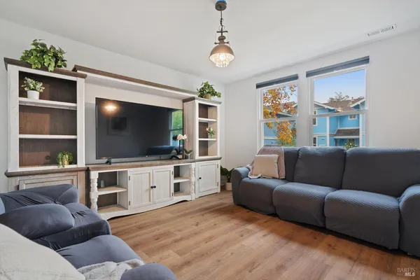 a view of a dining room with furniture window and wooden floor