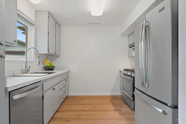 a stove top oven sitting inside of a kitchen