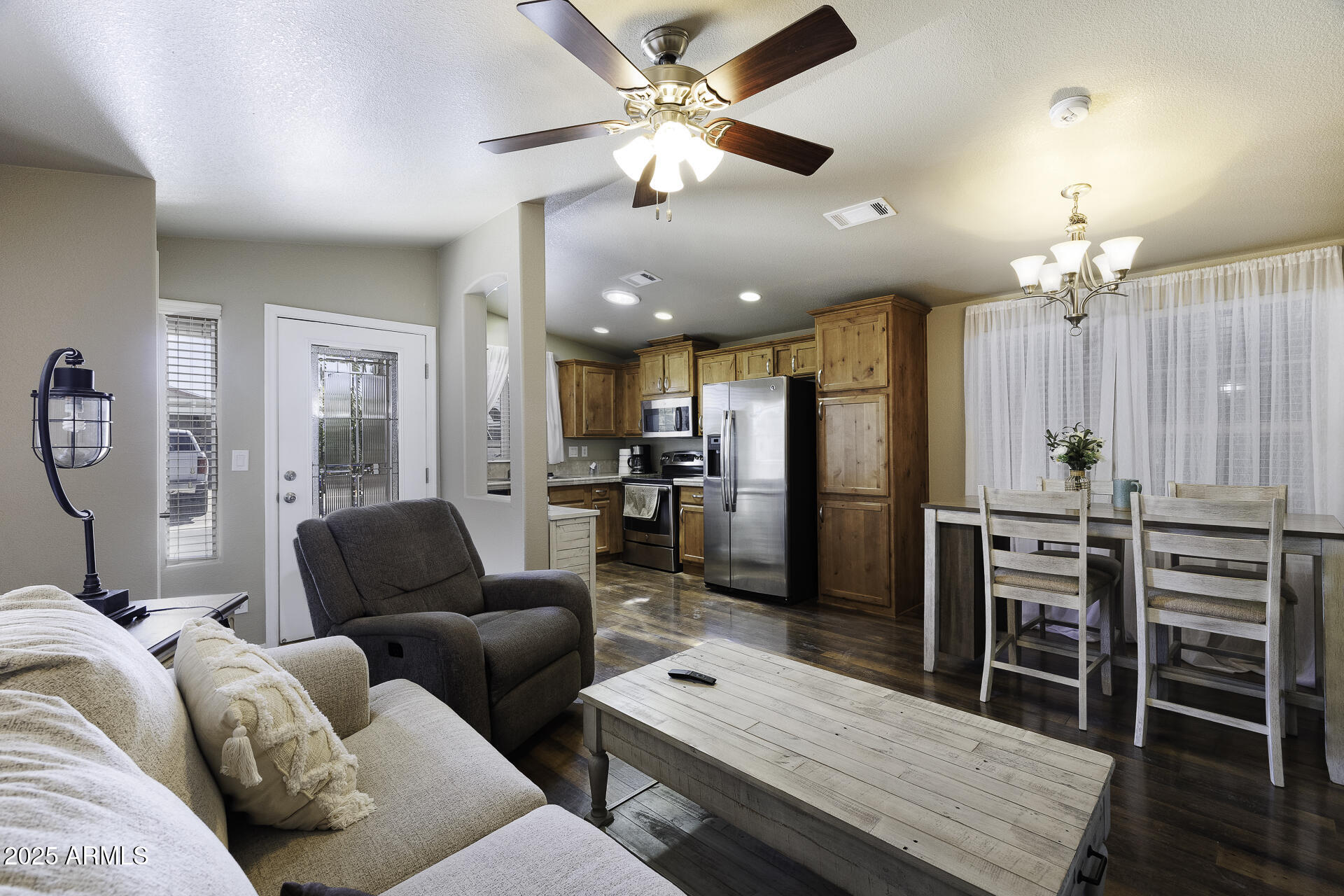 a living room with furniture a dining table and chairs with wooden floor