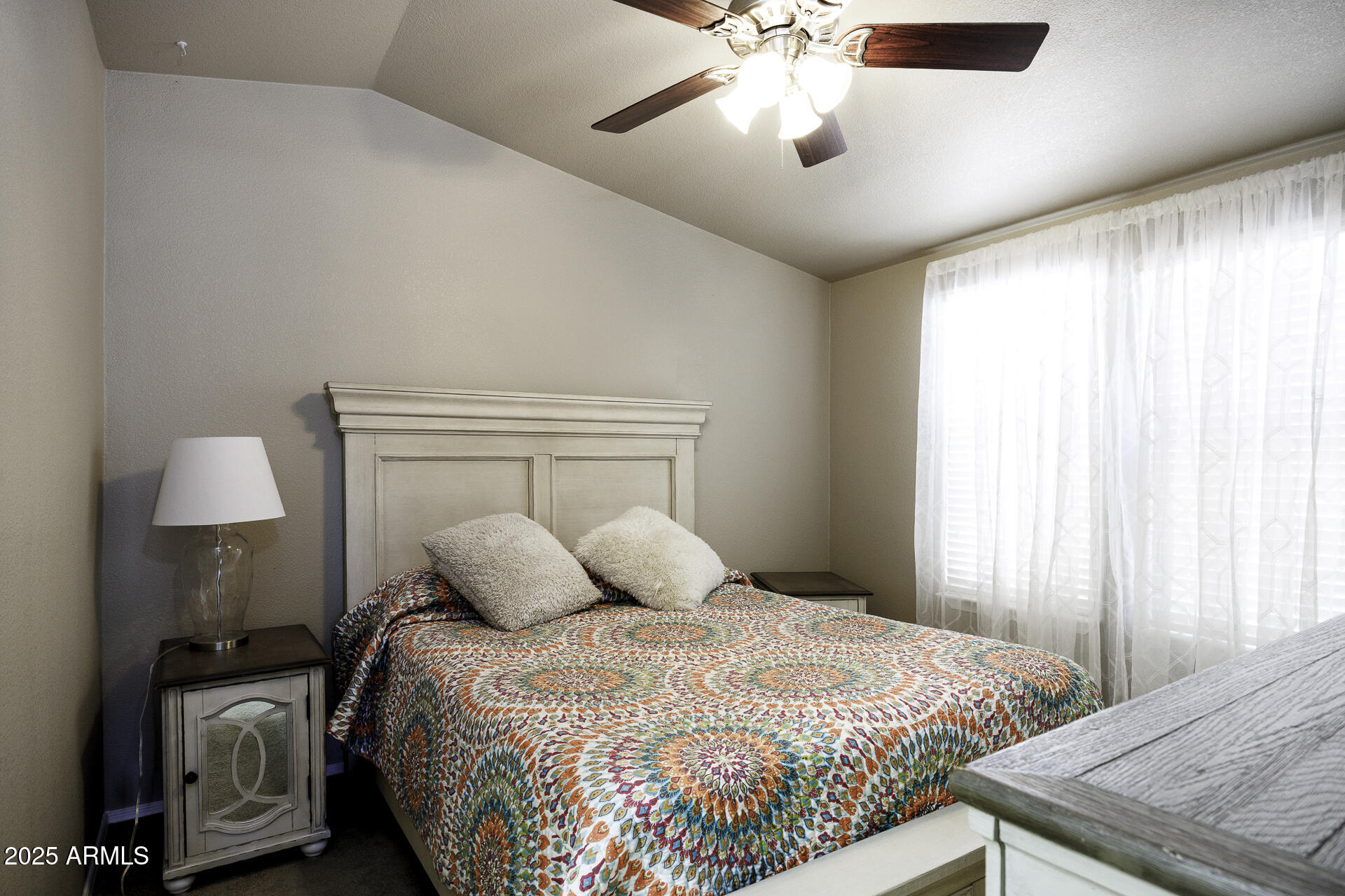 1110 North Henness Road, Unit 1351 Casa Grande, AZ 85122 - Photo 16 of 62 a bedroom with a bed and a chandelier
