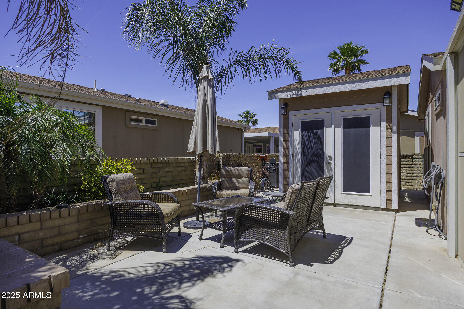 1110 North Henness Road, Unit 1351 Casa Grande, AZ 85122 - Photo 25 of 62 a view of a backyard with a patio and a fire pit