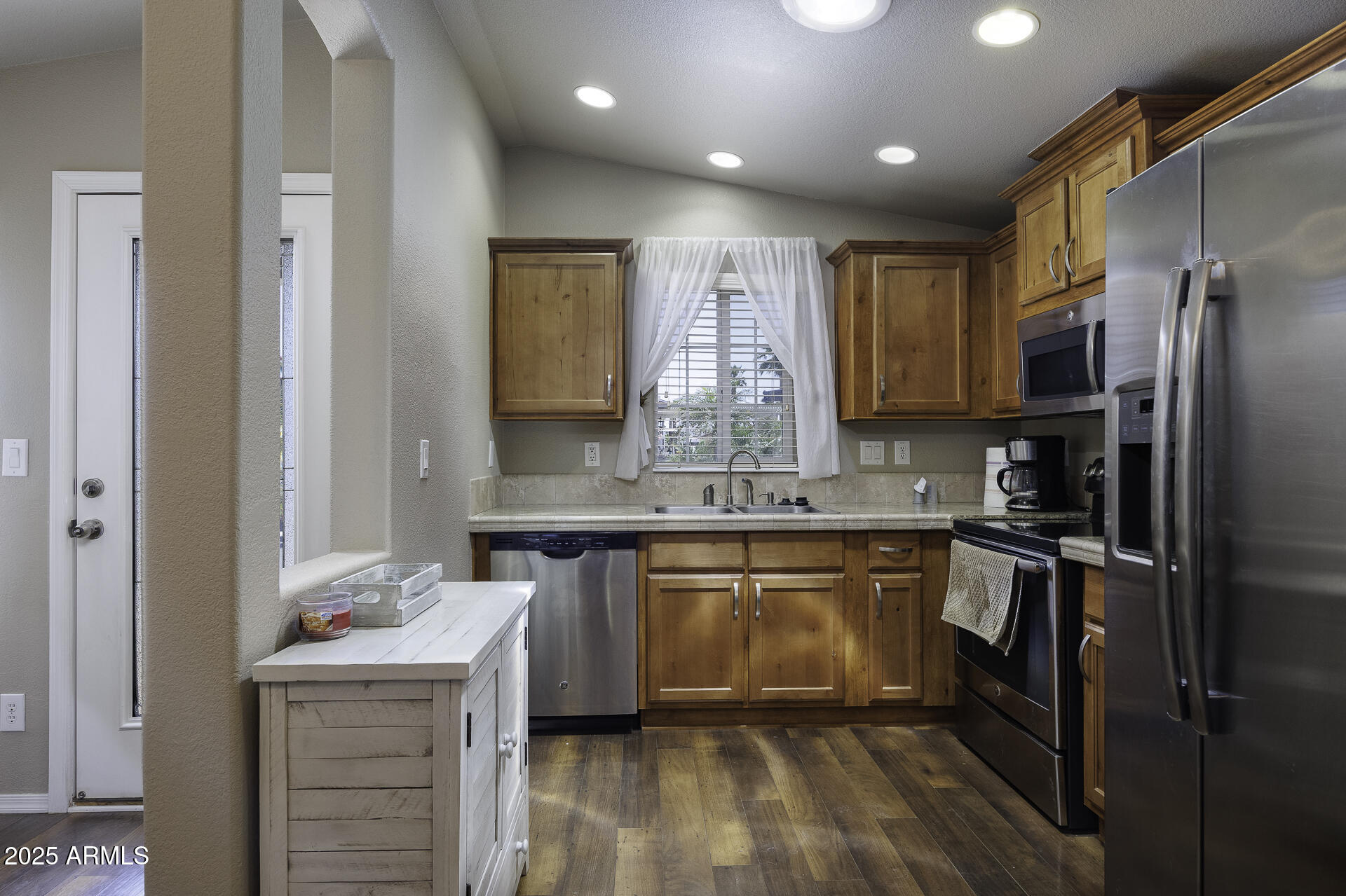 1110 North Henness Road, Unit 1351 Casa Grande, AZ 85122 - Photo 9 of 62 a kitchen with kitchen island granite countertop a sink cabinets and stainless steel appliances