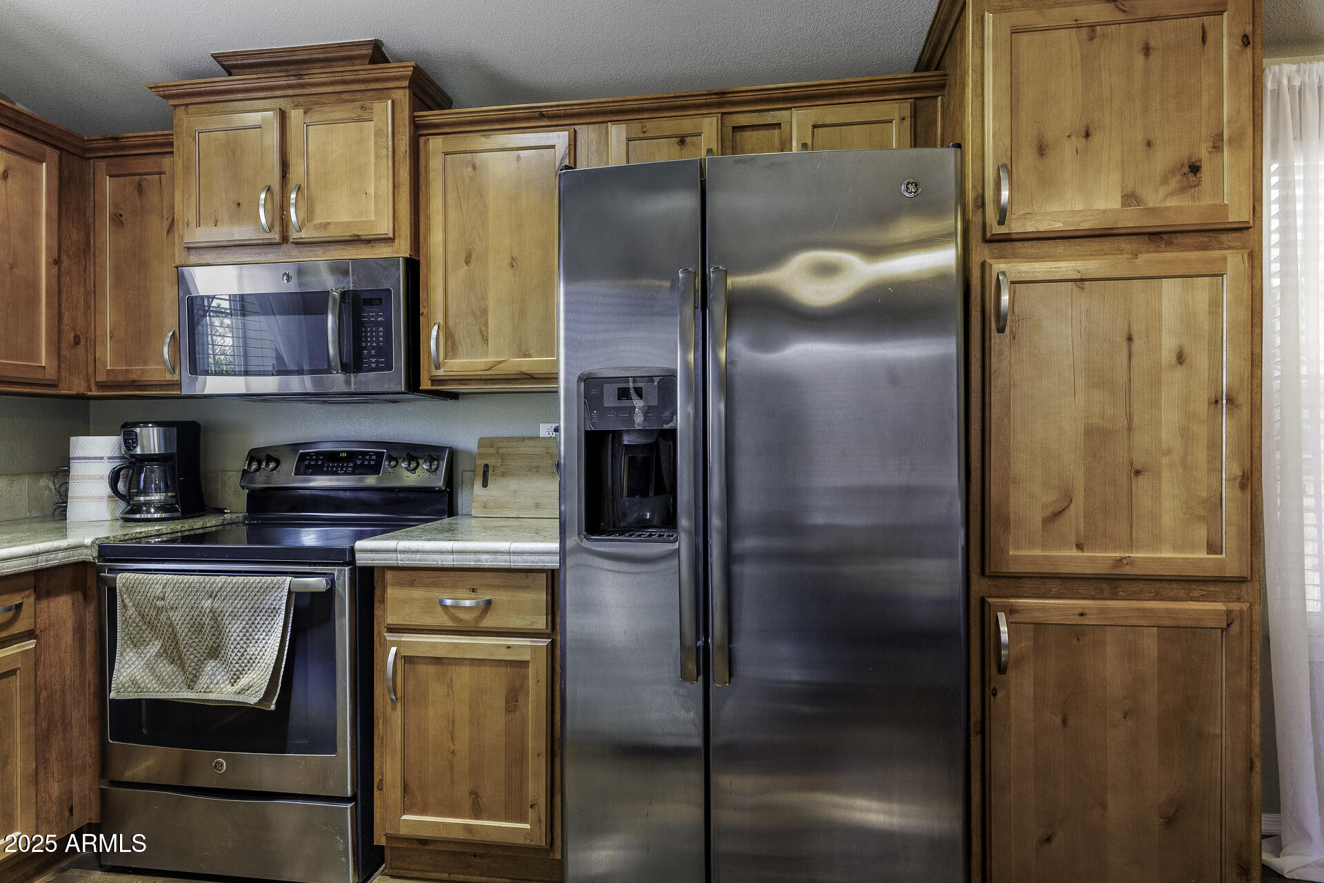1110 North Henness Road, Unit 1351 Casa Grande, AZ 85122 - Photo 10 of 62 a kitchen with stainless steel appliances granite countertop a refrigerator and a stove top oven