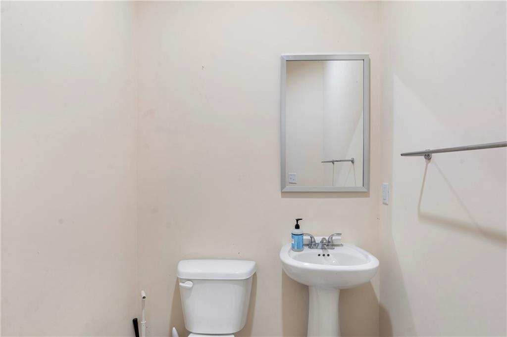 4265 Almanor Circle Norcross, GA 30071 - Photo 13 of 34 a bathroom with a sink mirror and toilet