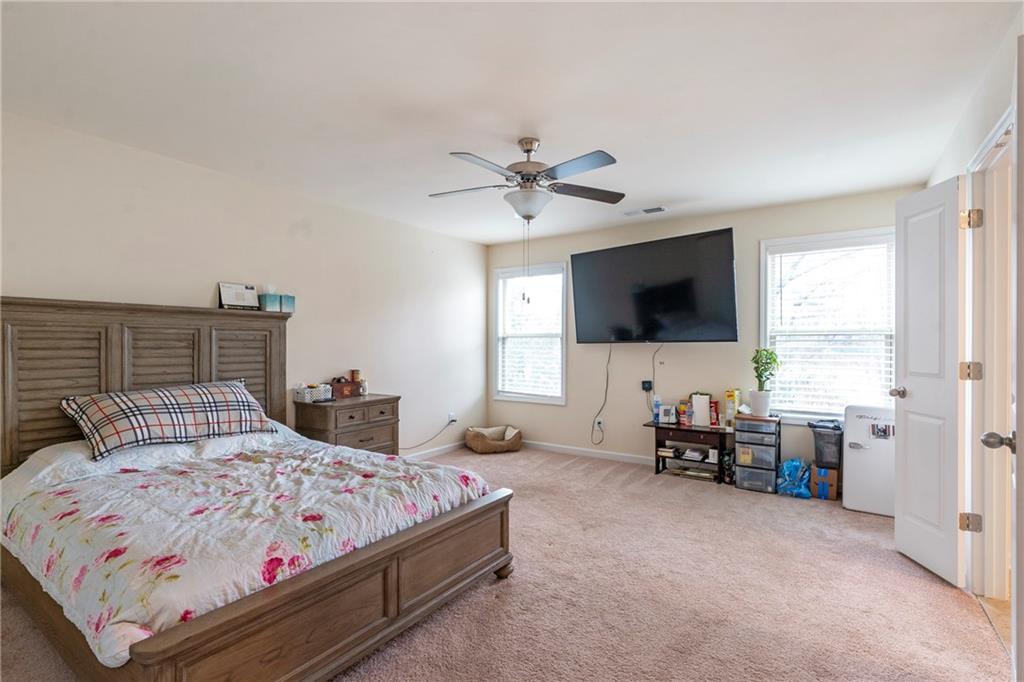 4265 Almanor Circle Norcross, GA 30071 - Photo 14 of 34 a bedroom with a bed and a flat screen tv