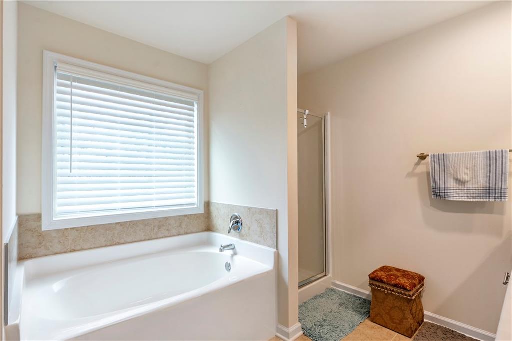 4265 Almanor Circle Norcross, GA 30071 - Photo 18 of 34 a bathroom with a bath tub and a window