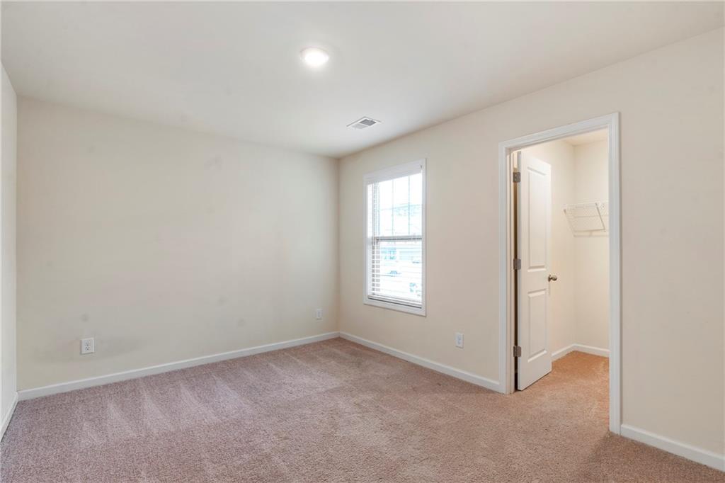 4265 Almanor Circle Norcross, GA 30071 - Photo 23 of 34 an empty room with windows and closet